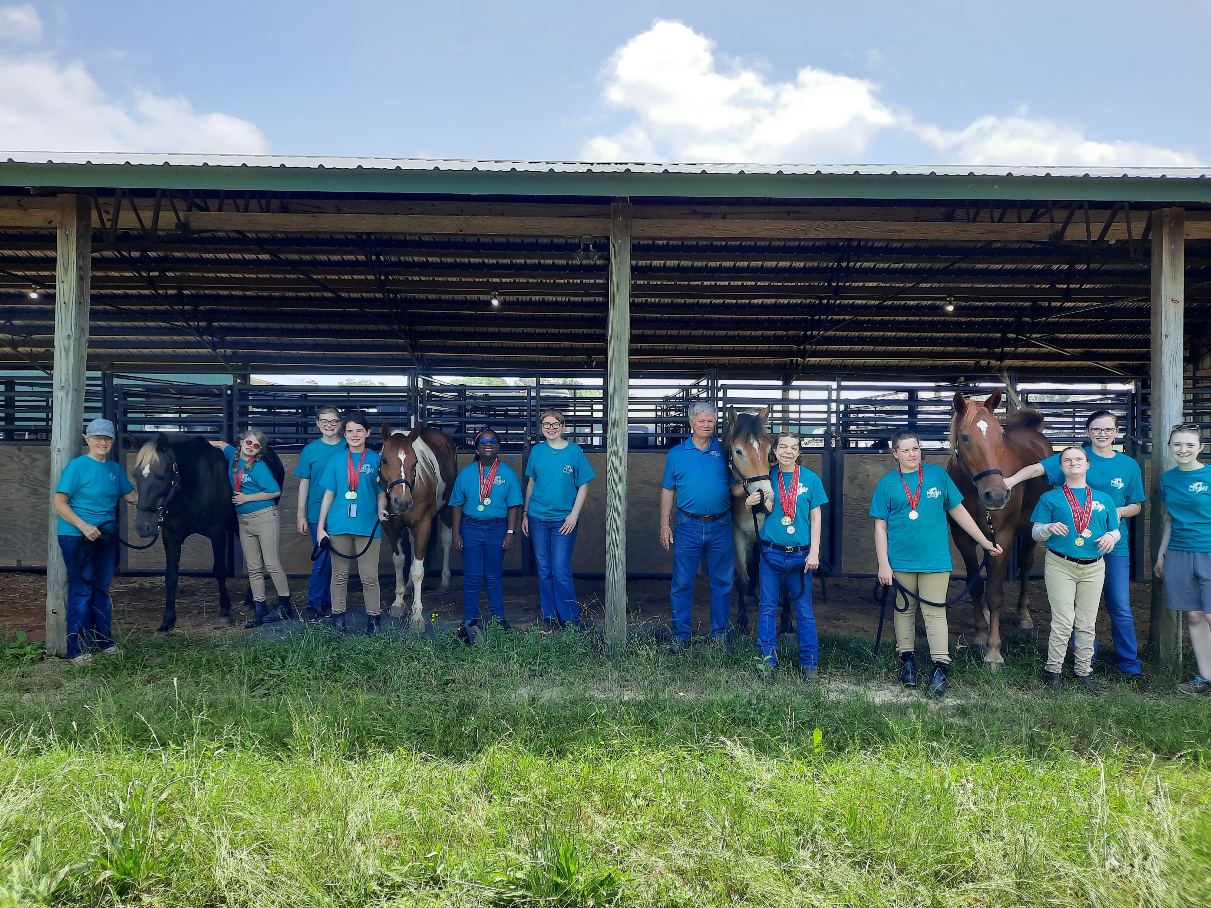Students from the 2023 Riders Club pose for a photo at the Special Olympics competition barn